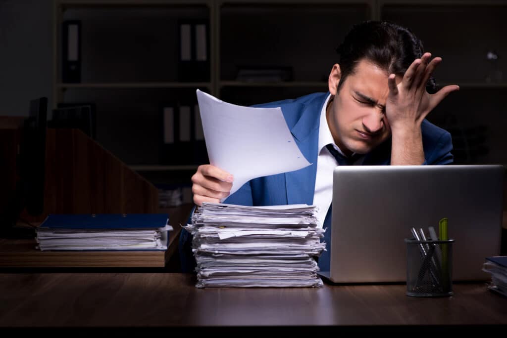Young male employee working night in the office